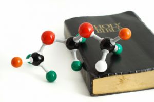 Model of molecules atop holy bible