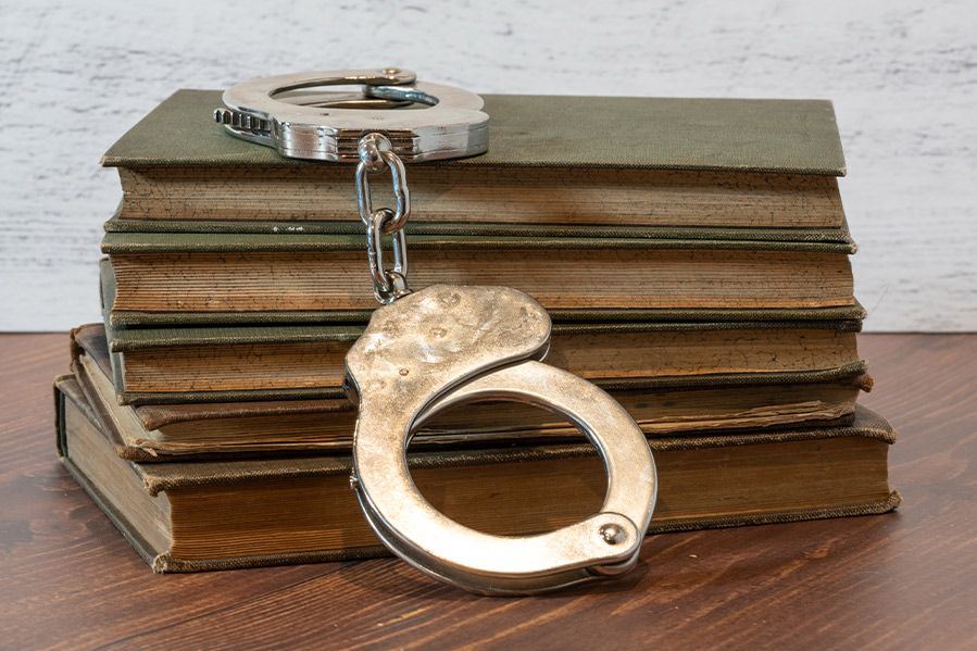 handcuffs laying on top of books