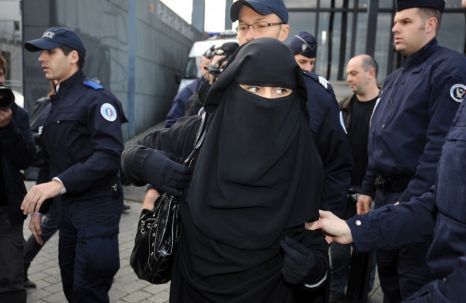 A woman being arrested in France for wearing a niqab