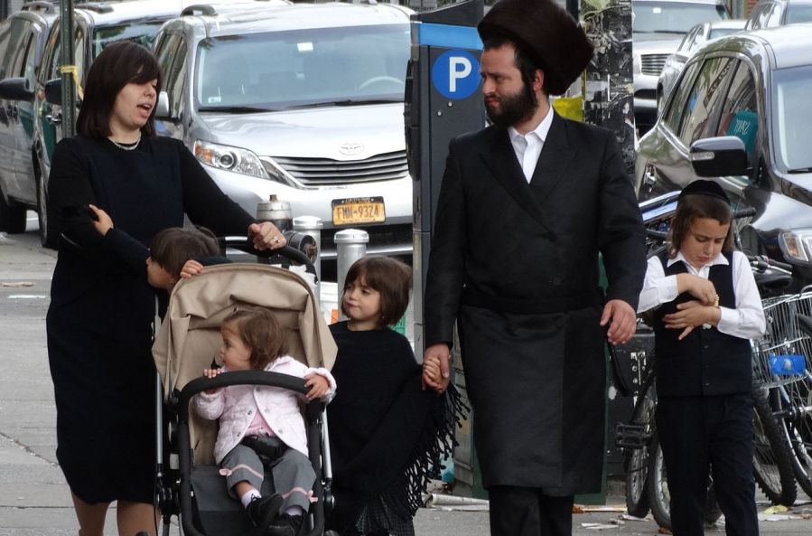 An Orthodox Jewish family walking on the street