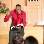 African American pastor preaching from church pulpit