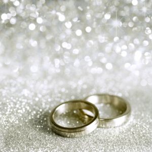 wedding bands on white sparkle background, wedding officiant