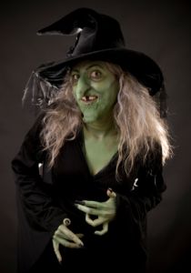 Halloween witch with green skin and pointy hat