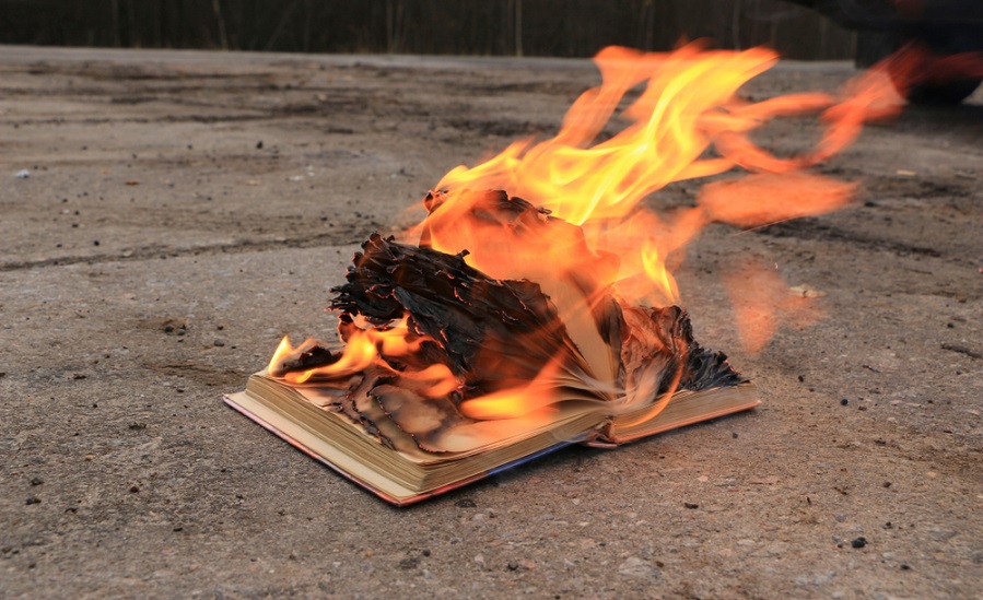 A book on fire on the ground