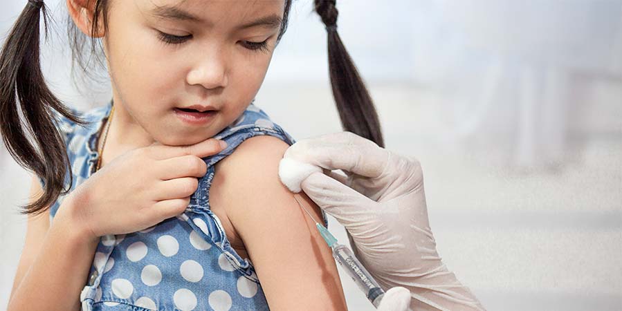 A young girl receiving a vaccine