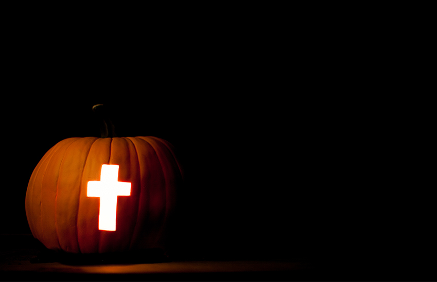 A cross carved into jack o lantern