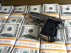 Handgun on pile of cash
