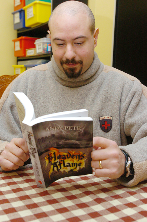 rev andy pete holding his book heaven's aflame