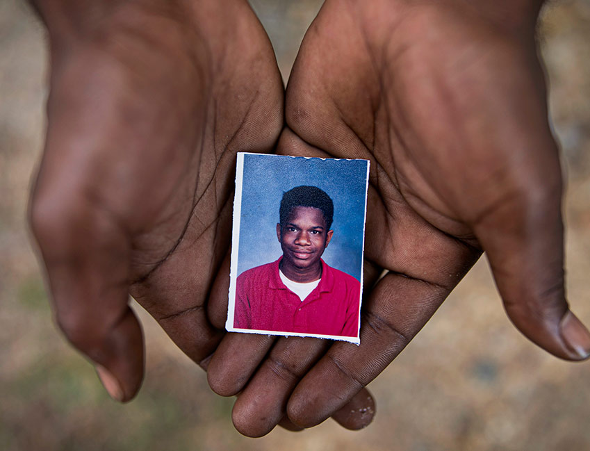 Joshua Love holds photo of himself at age of Catholic Church abuse