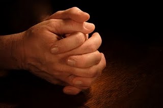 hands folded together in prayer
