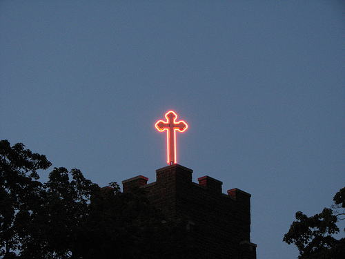 red neon sign in shape of cross