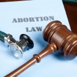 abortion law book with legal gavel