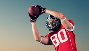 player in red jersey catching a football