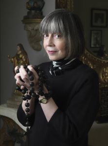 Author Anne Rice holding black beads
