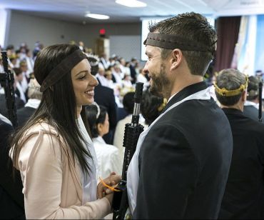 A number of couples said wedding vows while holding guns.