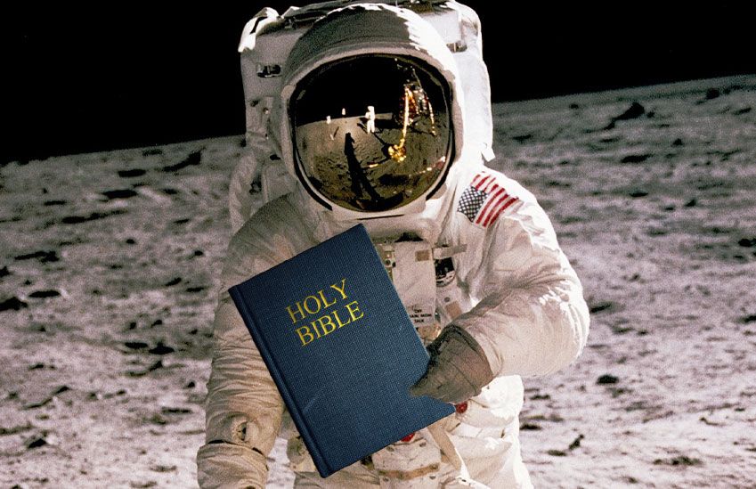 An Astronaut Holding the Holy Bible