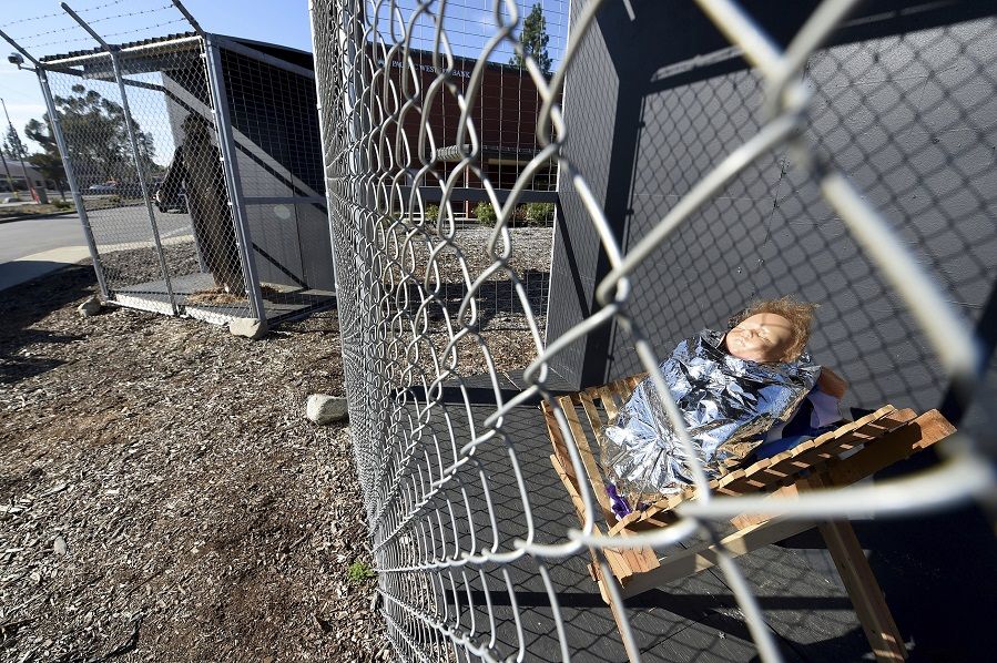 Baby Jesus in a caged nativity scene