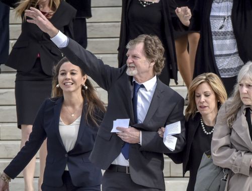 Jack Phillips waves to the crowd outside Supreme Court