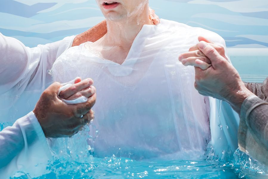 man getting baptized in water