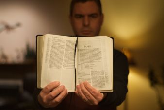 Open Bible turned to the Book of James, which includes teachings about prayer and healing.
