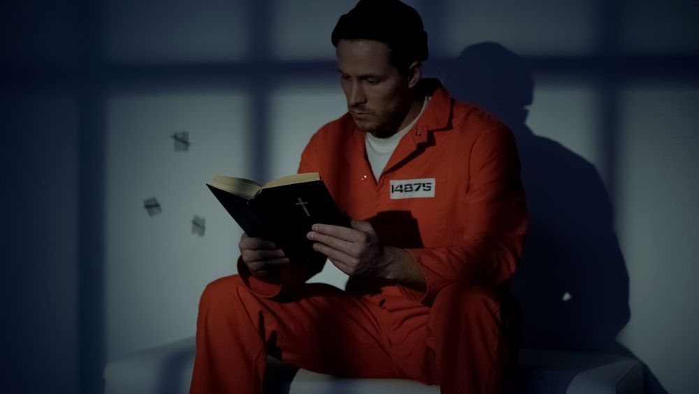 A prisoner holding a Bible