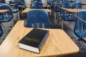 Bible sitting on desk in classroom