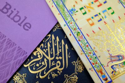 The covers of the Bible, the Qur'an, and the Torah