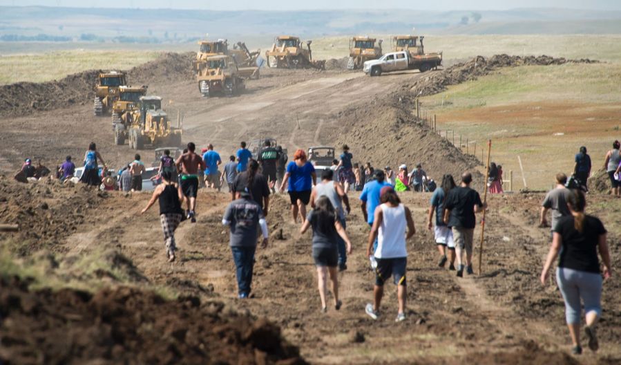 Native American protesters confront pipeline workers in North Dakota.