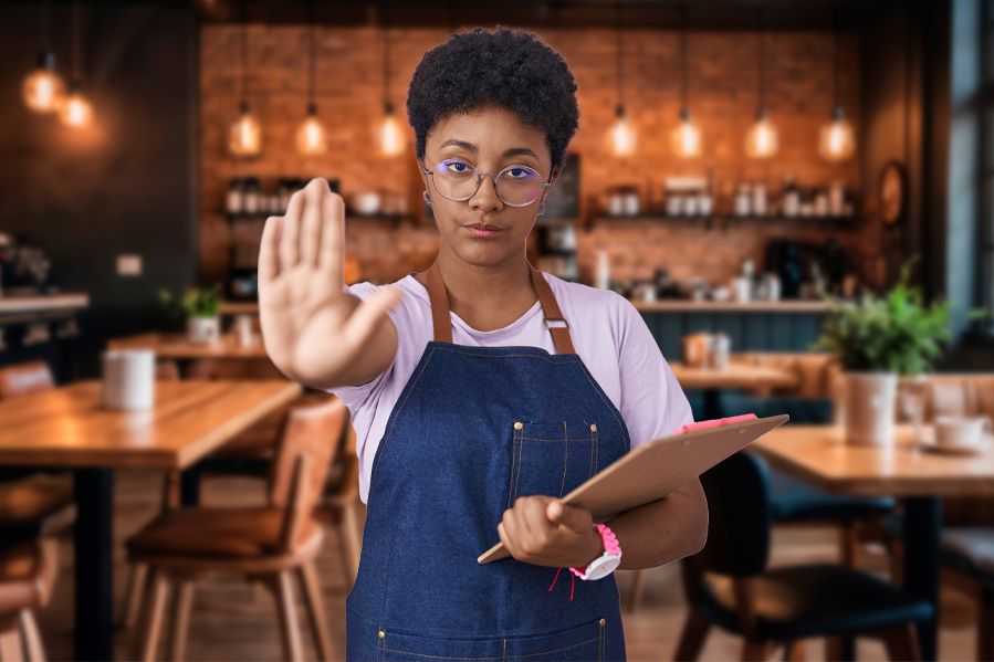 restaurant worker with hand outstretched in stop symbol