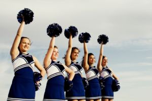line of girl cheerleaders in blue and white