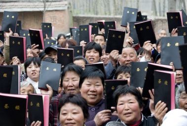 Christians in China display their Bibles.