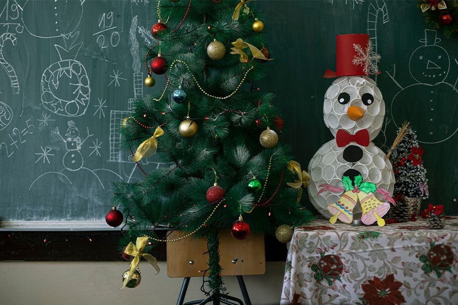 christmas tree in front of chalk board at school