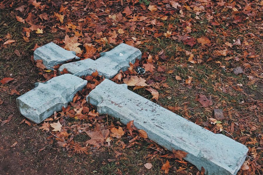 christian cross broken on ground