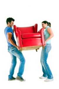 man and woman carrying loveseat together