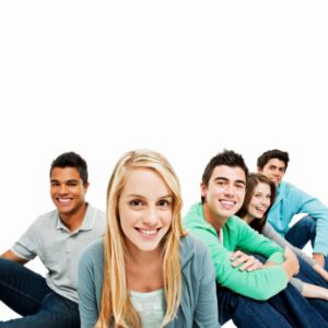 group of young adults sitting against white backdrop