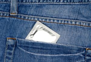 Condom sticking out of jeans back pocket