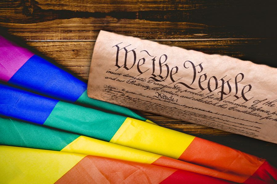 The US Constitution laying atop LGBT flag