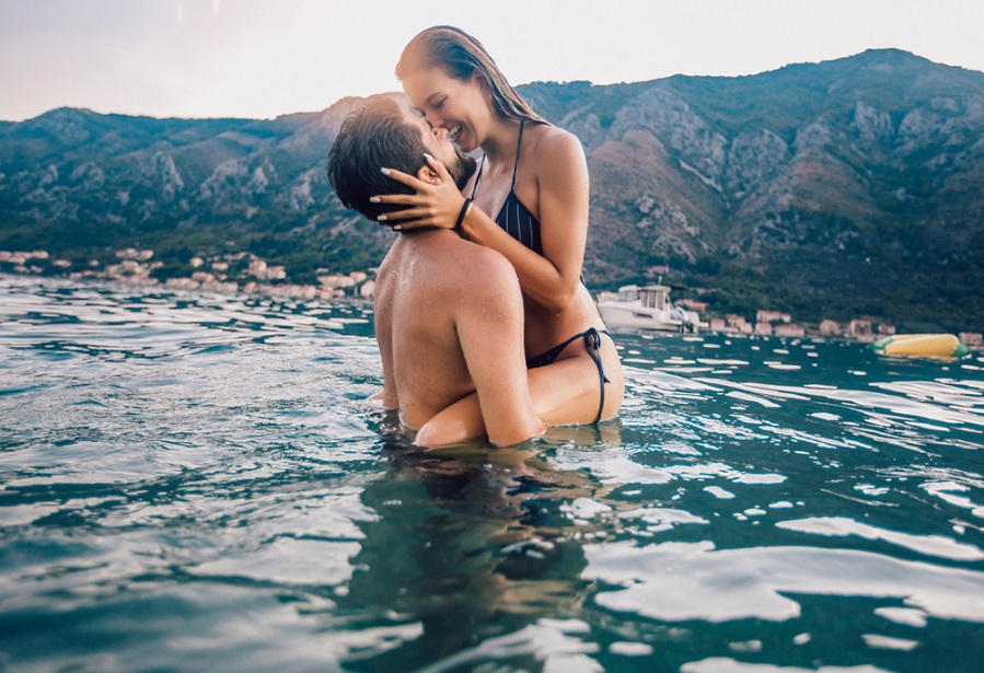 Young couple kissing in the water