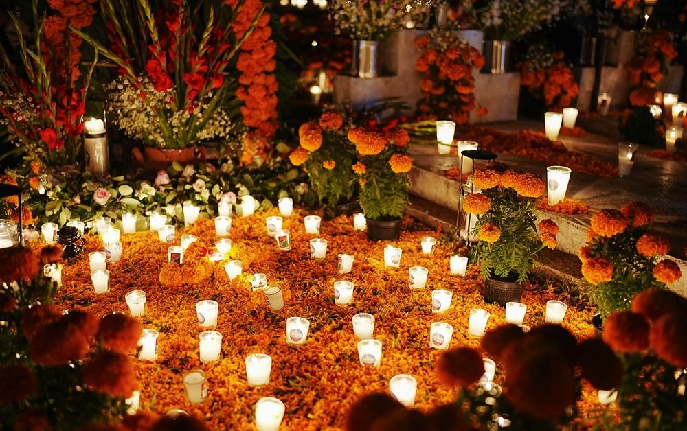 Traditional Dia de los Muertos decorations in a graveyard. Graves are decorated to honor deceased loved ones.