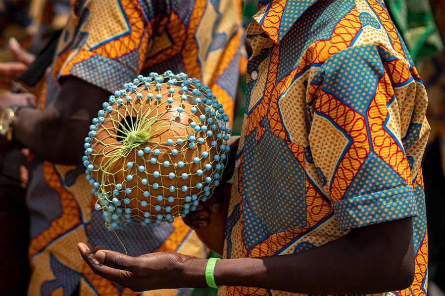 drummer playing gourd percussion during festival of yams