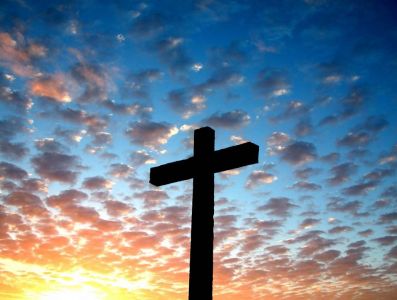 A Christian cross silhouetted on the skyline