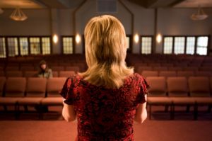 female pastor preaching to empty church