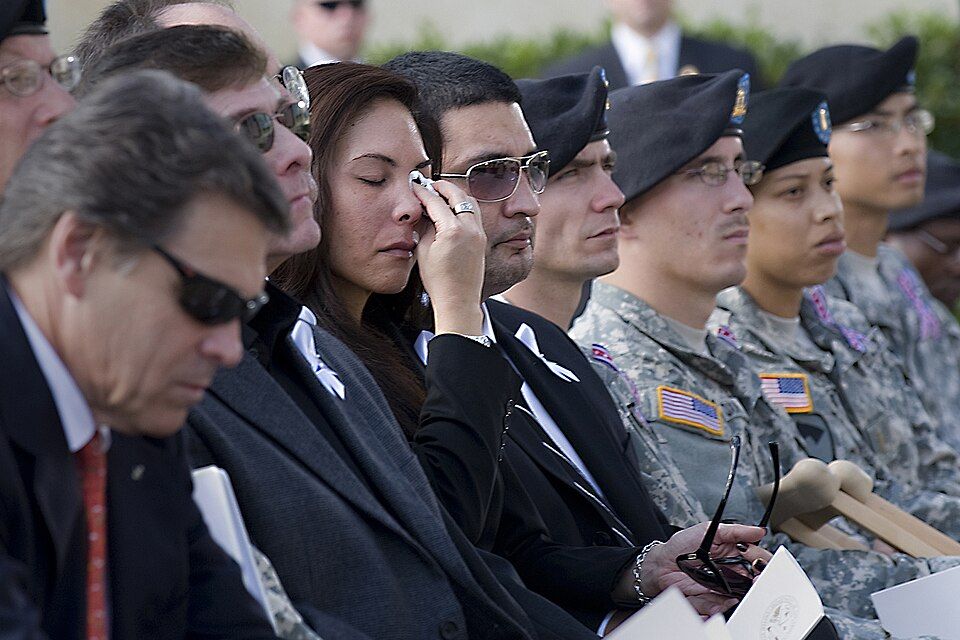 Families and soldiers gather at a memorial service honoring the victims of the 2009 Fort Hood shooting.
