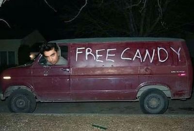 A minister driving a van marked 'free candy'.