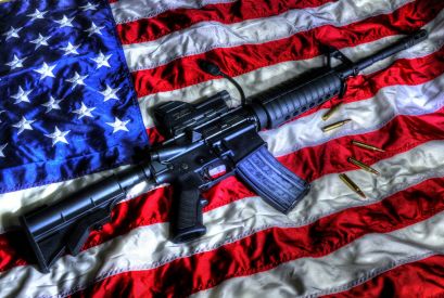 A gun sitting on an American flag.