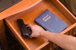 Open drawer with bible and handgun inside