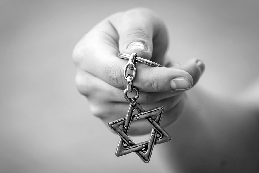 black and white image of hand holding star of david
