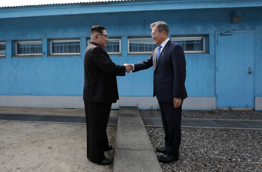 North Korean leader Kim Jong Un shakes hands with South Korean president.