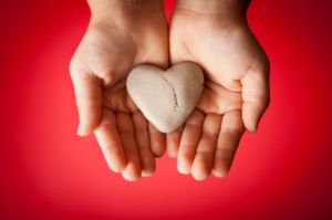 man holding heart in his hands