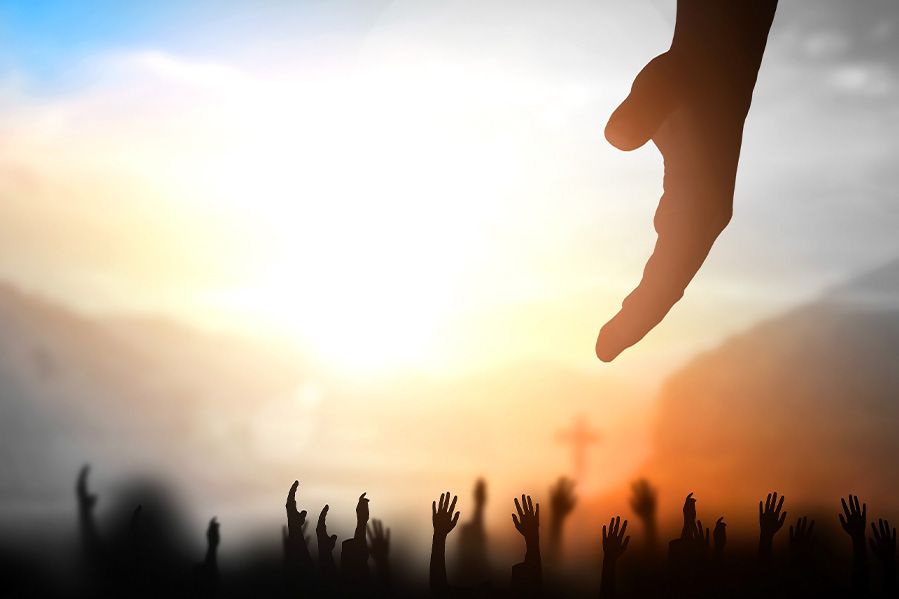 hand reaching down to help migrants